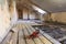 Interior of apartment during on the renovation and construction. Chainsaw on partially dismantled wooden floor and sawdust