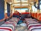 Interior of an Arab minibus for excursions through the desert. Old jeep with seats with striped fabric and curtains. Old Transfer