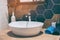 Interior of bathroom with sink basin faucet and mirror.