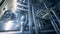 Interior of a brewery plant filled with steel equipment and canisters