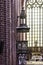 Interior of a brick cathedral in the Gothic style. A decorated anbon and a large stained glass window.