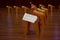 Interior of buddist temple called pagoda. Small plastic tables with praying books are staying in a lines on floor.