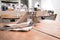 Interior of cafe showing laid wooden tables with cutlery in shabby chic rustic styled eating area