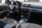 The interior of the car Mazda 3 with a view of the steering wheel, dashboard, seats and multimedia system with light gray trim and