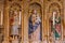 Interior of cathedral of Saint Jacob with old statues and candles. Medieval saint statues. God Mother with Jesus baby and saints.