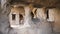 Interior of cave halls carved into mountain with pillars supporting ceiling in historical rock-hewn city of Uplistsikhe