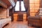 Interior of a chimney hall in a wooden house with a cast-iron retro radiator under the window