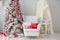 Interior with Christmas tree, armchair, crib