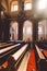 The interior of the church with benches, a beautiful big chandelier and sunligh