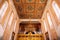 Interior of Church of the Holy Annunciation in the old town of Dubrovnik, Croatia. Golden chandelier with bulbs.