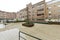 Interior common areas of an interior block patio with a swimming pool and stoneware floors in an urban residential development on