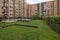 Interior common areas of a residential complex with a lot of grass, trees,