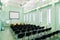 Interior conference hall with lots of chairs and a flip chart an