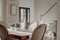 Interior of a contemporary residence with a stylish wooden dining room table and matching chairs