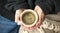 Interior cosy woman hands holding cup of coffee or chocolate with sweater and blanket