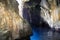 Interior of a dark sea grotto with limestone rocks. Cliff.