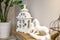 Interior decoration toys. White decorative wooden latern lights and ceramic horses in expensive interior