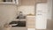 Interior design depth of field, cosy kitchen. Induction hob, pan with fried egg. Refrigerator. Ceramic tiles. Environmental