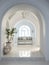 Interior design of Greek island style entrance hall with arched doorway