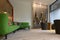 Interior design with green sofa chairs and black vertical metal flower