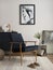 Interior design of harmonized living room with blue commode, elegant velvet armchair, coffee table, mock up poster frame, side