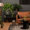 Interior design of living room interior with mock up poster frame, brown sofa, plants, glass sideboard, black coffee table,