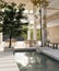 Interior design of a luxurious, spacious hotel indoor lounge with an indoor pool and trees