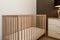 Interior design in pool villa, house, home, condo and apartment feature wooden baby cot, baby crib and drawer