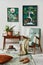 Interior design of retro living room with stylish vintage armchair, shelf, house plants, decoration and mock up poster frame.