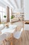 Interior design spacious bright studio apartment in Scandinavian style and warm pastel white and beige colors. trendy furniture in