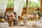 Interior design of summer gazebo by the lake with stylish rattan armchair, coffee table, sofa, pillows, plaid, accessories.