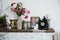 Interior design vases with flowers and candles clock brick fireplace