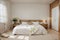 interior design of wooden bedroom with bed and a vase of calla lily flowers