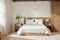 interior design of wooden bedroom with bed and a vase of calla lily flowers