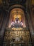 Interior details of Curtea de Arges monastery. The altar and ornate walls with painted icons and a golden chandelier with lights