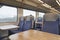 Interior of an empty commuter train carriage with seats