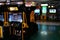 Interior of an empty darkened amusement arcade hall