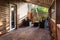 Interior of empty hall veranda in wooden village vacation home with vintage lamps and chairs