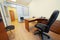 Interior of empty office cabinet with armchair