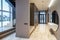 Interior of entrance hall with staircase in luxury house. Grey tones