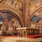 Interior Famous Basilica of St. Francis of Assisi Basilica Papale di San Francesco with Lower Plaza at sunset in Assisi, Umbria,