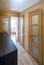 Interior of the flat. Warm tones, wooden floor. Doors. Hall.