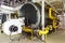 Interior gas boiler room with large boilers and burners