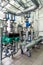 Interior gas boiler room with multiple pumps and piping