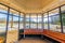 Interior of a gazebo with wooden benches and open windows