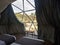 Interior of a geodesic glamping tent with beds and transparent roof to see the sky and stars