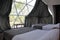 Interior of a geodesic glamping tent with beds and transparent roof to see the sky and stars