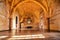 Interior of the historic hall with original artwork. This is the main room of a castle with arches supporting the roof. (Rocca