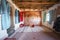 Interior of a historic room decorated with Berber carpet and clothes in Ait Ben Haddou, Morocco