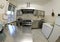 Interior of a industrial kitchen with stove and large stainless steel hood and freezer photographed with a fisheye lens